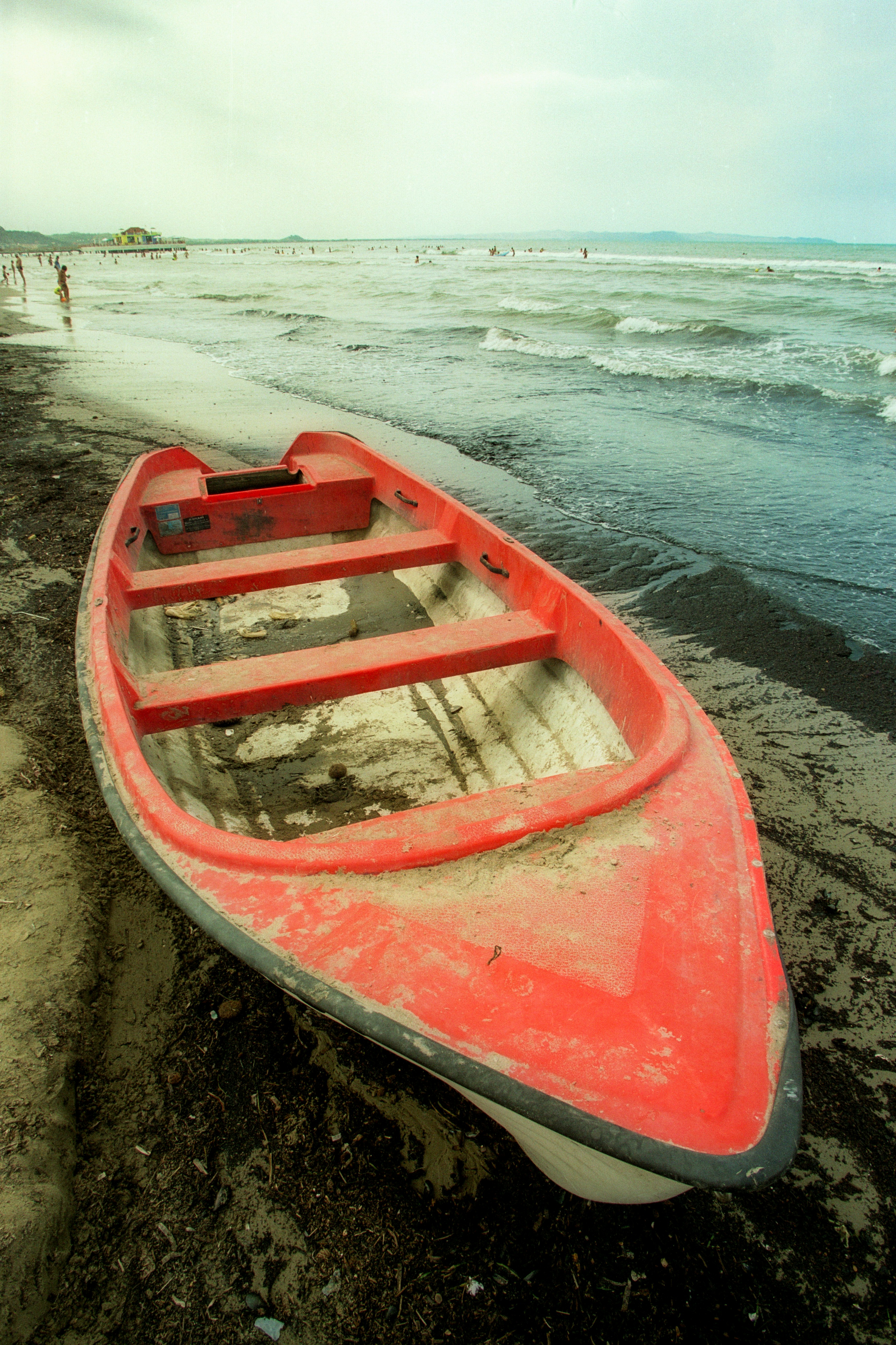 red and white boat on seashore during daytime